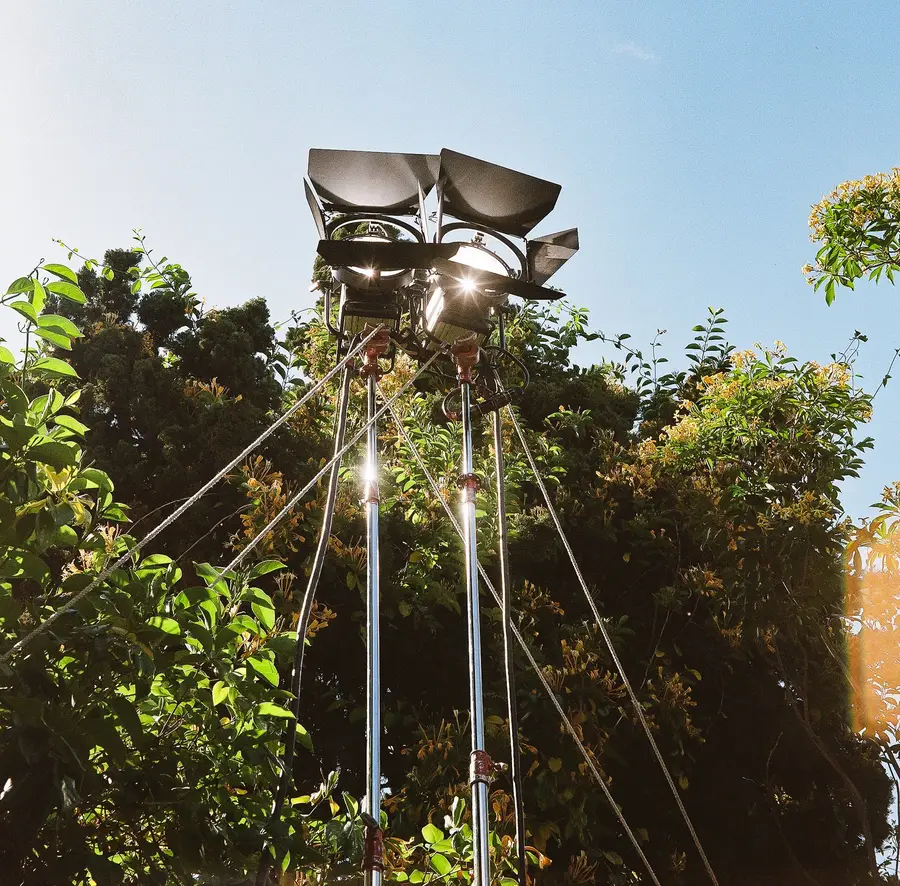 Outdoor film light rig above greenery